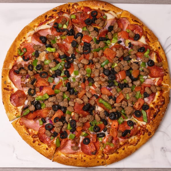 A whole Can Am Pizza with pepperoni, sausage, ham, olives, green peppers, and tomatoes.