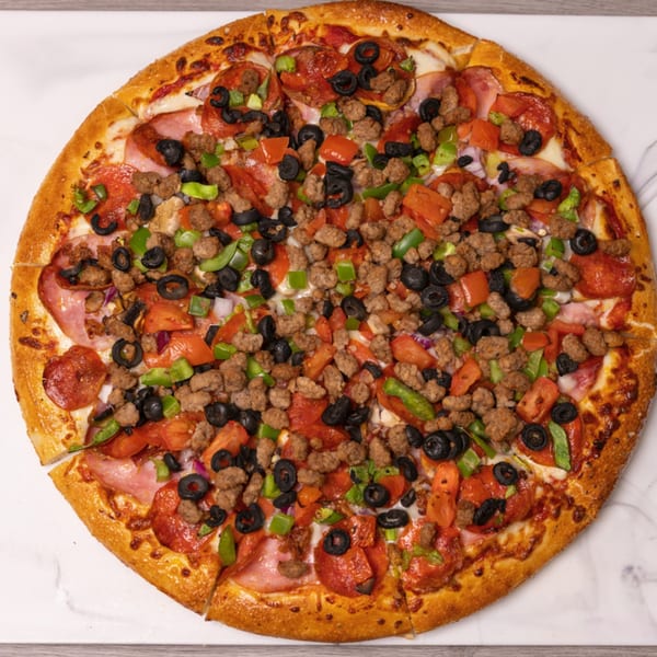 Can Am Pizza's large, round pizza with pepperoni, sausage, ham, olives, green peppers, and tomatoes.