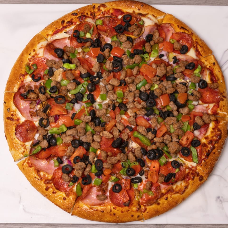 Can Am Pizza's large, round pizza with pepperoni, sausage, ham, olives, green peppers, and tomatoes.